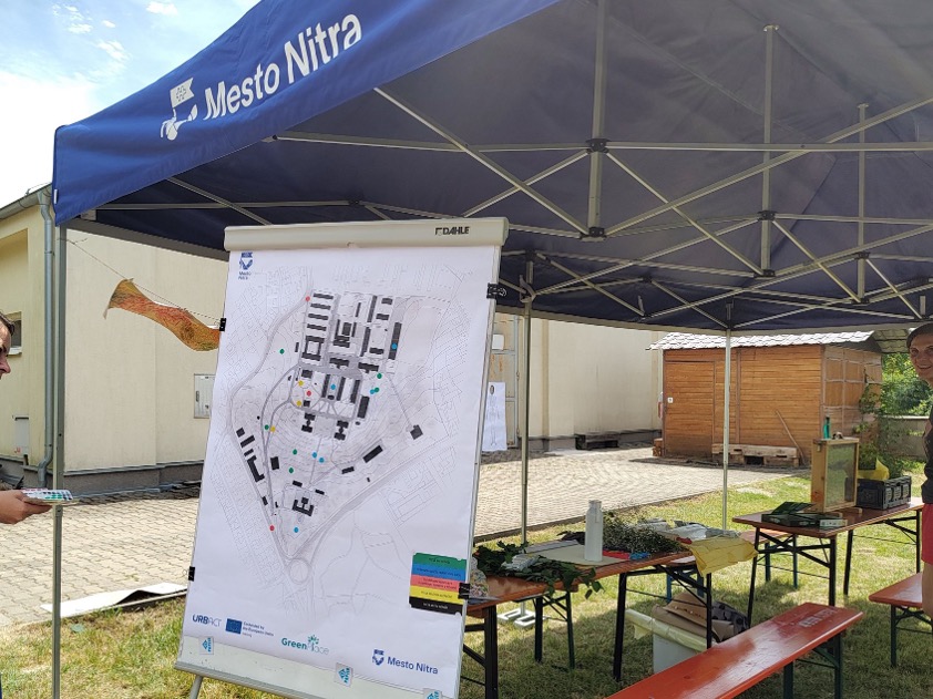 An flipchart with a map of the Martin's Hill area standing under big blue festival tent.