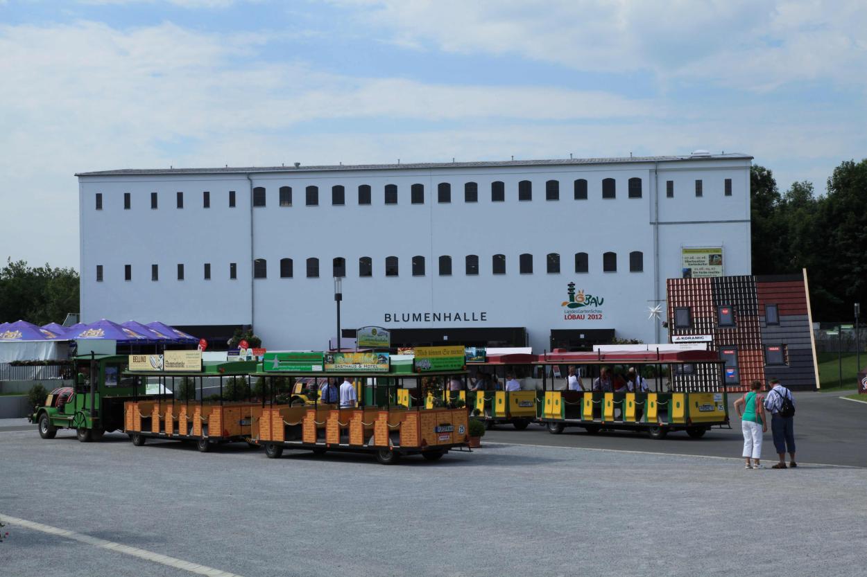 The white renovated building and trackless sightseeing vehicles for tourists