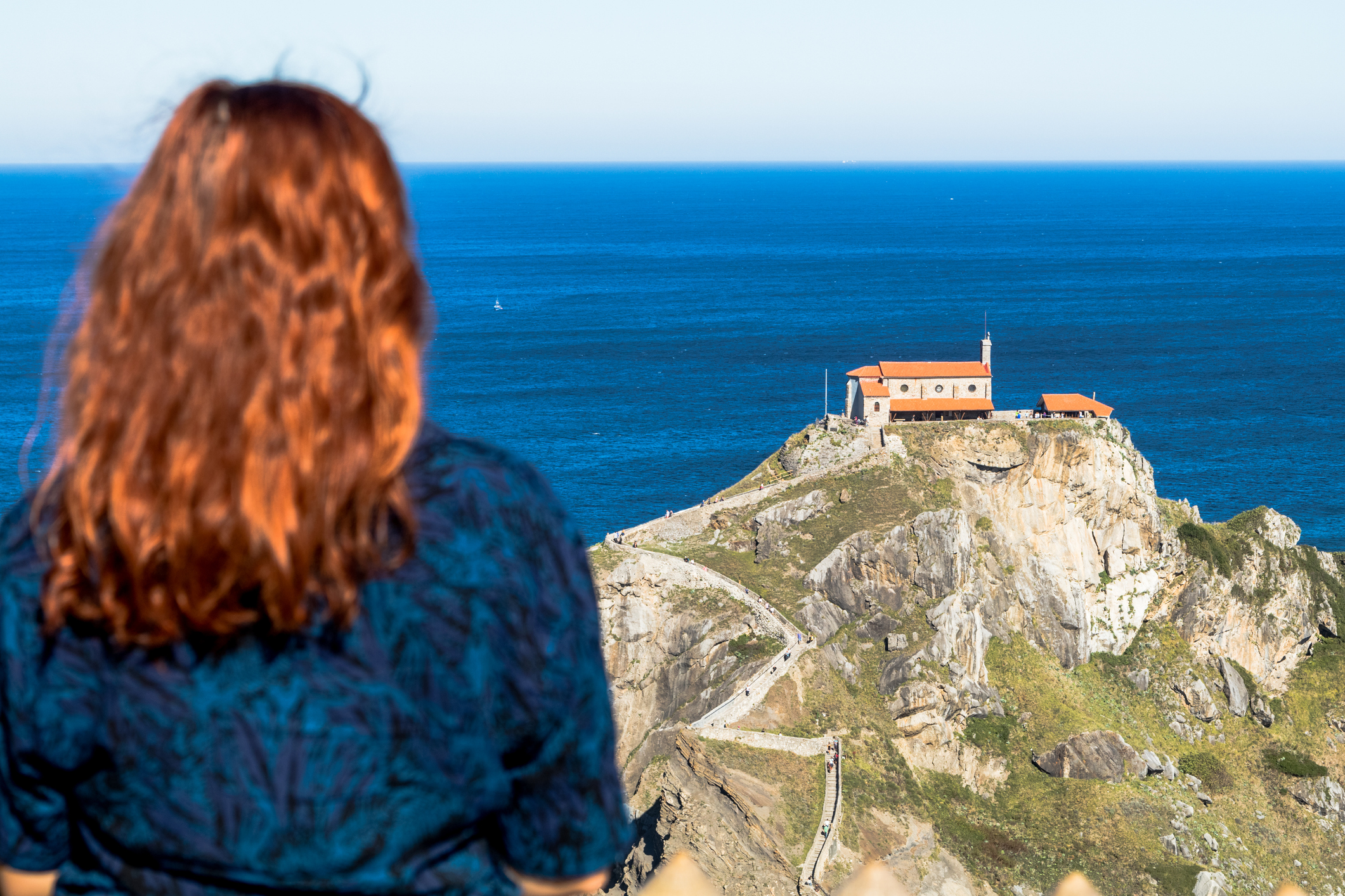 Woman in San Juan de Gaztelugatxe (Basque Country) - IStock