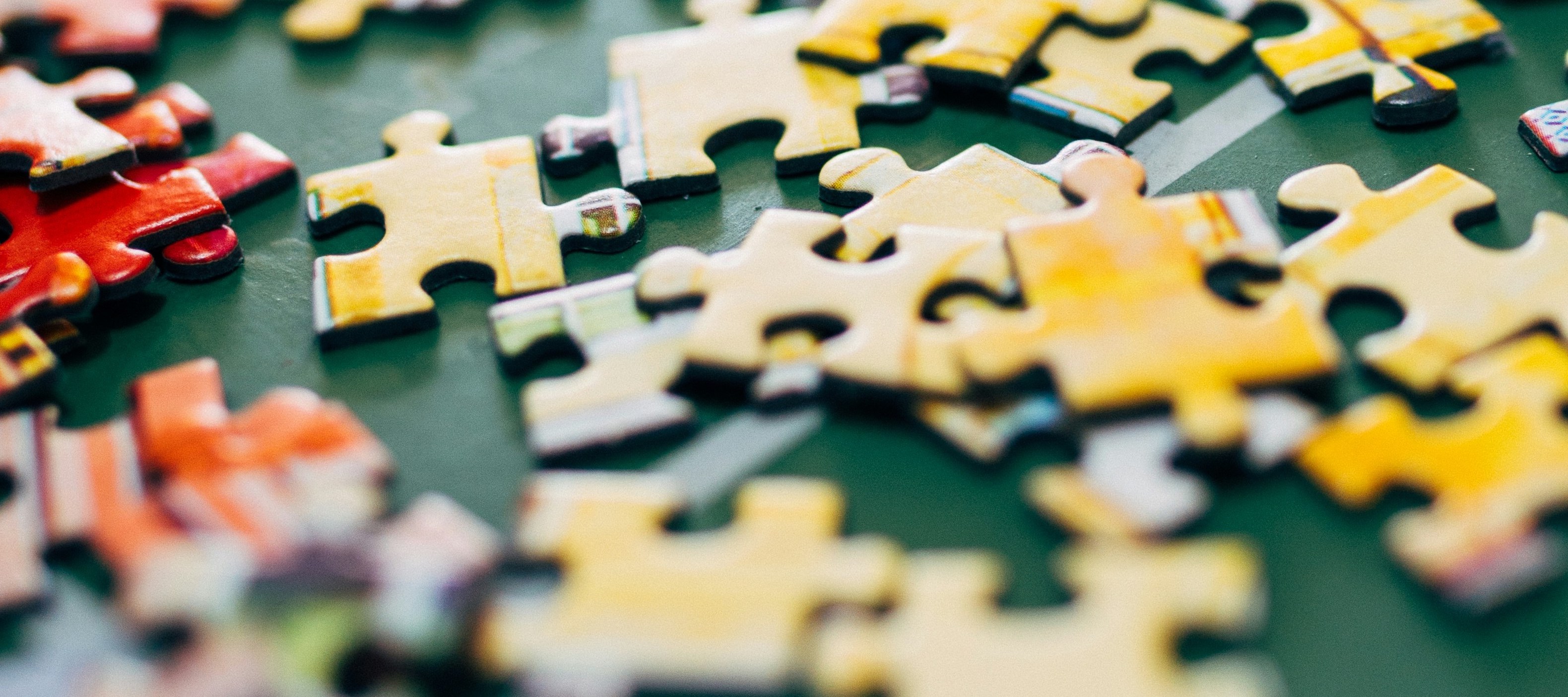 Pieces of a puzzle on a green table