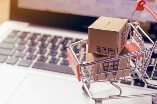 A shopping trolley on a computer keyboard. Credits: Canva.