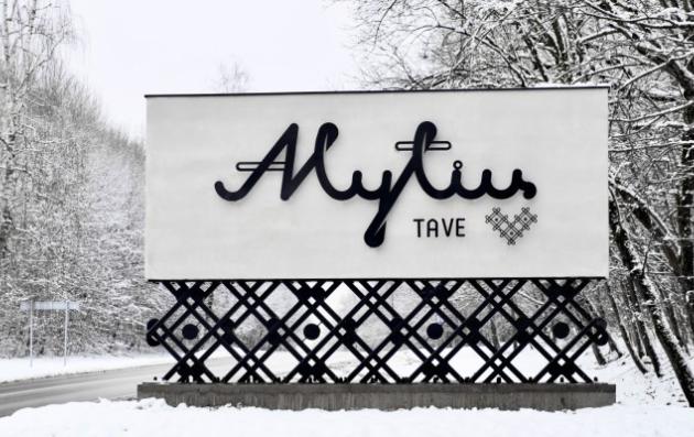 A winter scene featuring a large sign