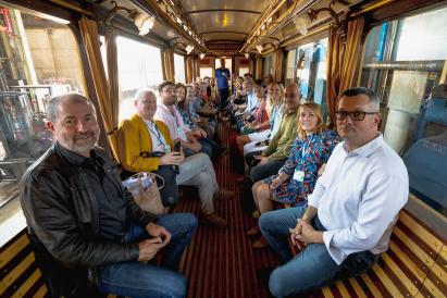 a color photo with people sitting in an historic train